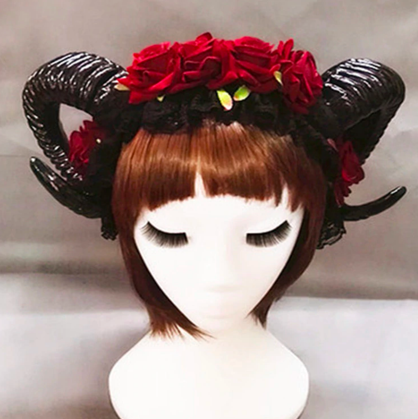 Demon horn headband with black curled horns and red roses.