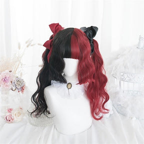 Black-and-red split-color wig with full bangs and loose curls, displayed on a white mannequin with contrasting red and black bows above the sides.