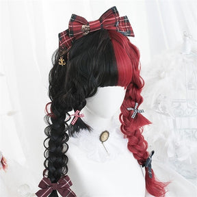 Angled close view of the black-and-red wig in thick twin braids, decorated with a large plaid bow, smaller ribbon ties and a tiny gold-tone charm.