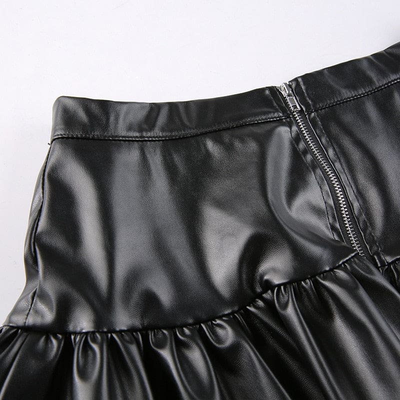 Close detail of the rear waistband on the black faux leather skirt, with the centre-back zipper and seam stitching visible.