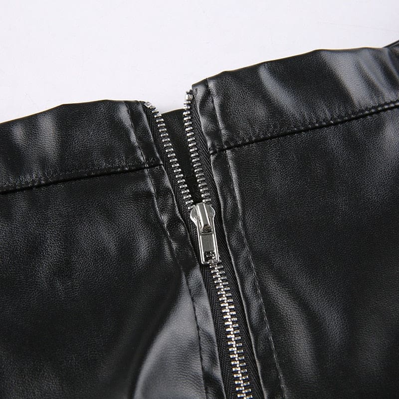 Close-up of the black skirt’s opened back zipper, showing the zipper teeth and inner edge of the waistband.