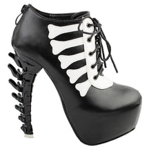 Black platform ankle boot in an outer-side view, showing pale bone-shaped trim, front laces and a sculpted black spine heel.