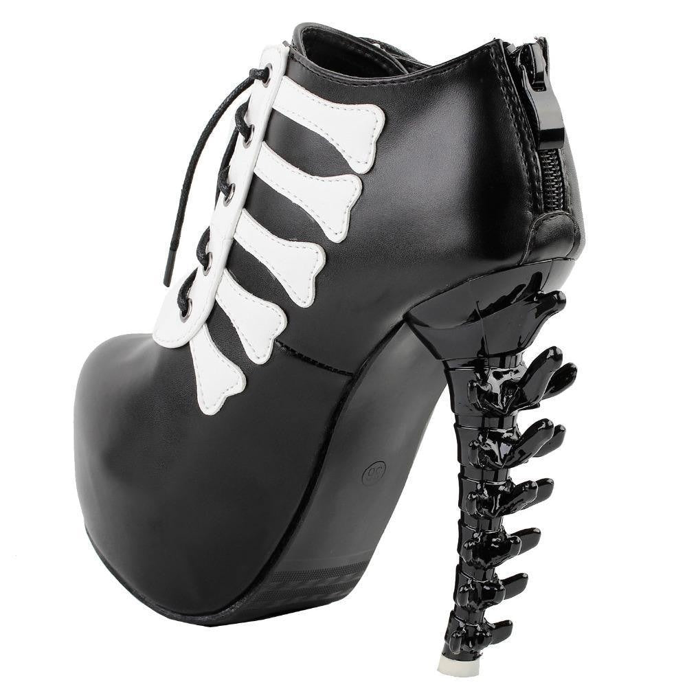Black skeleton ankle boot viewed from the back and side, with the rear zipper, curved sole and spine-shaped heel visible.