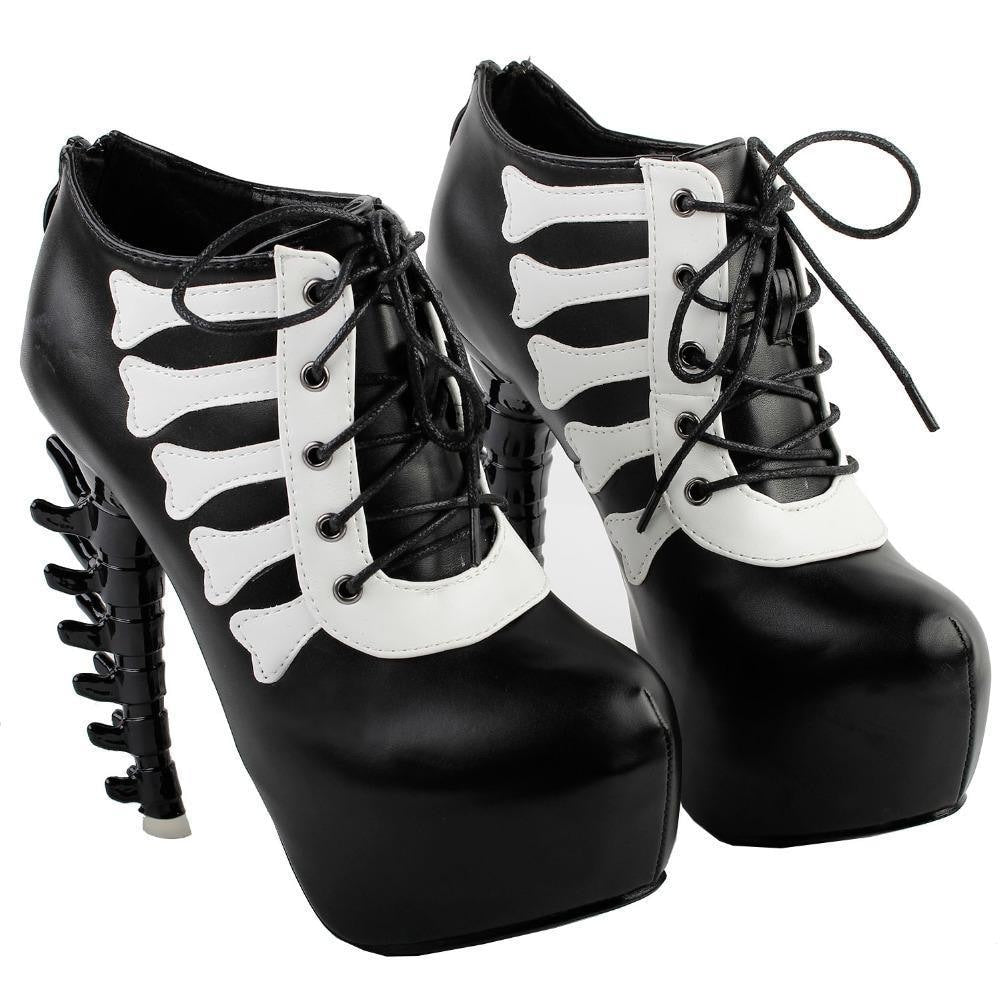 Pair of black skeleton platform boots arranged together to show their lace-up fronts and pale bone-shaped trim.
