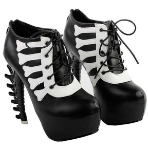 Pair of black skeleton platform boots arranged together to show their lace-up fronts and pale bone-shaped trim.