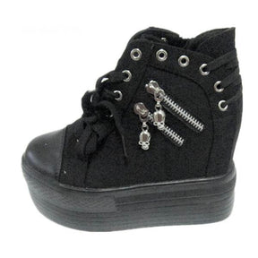 Black high-top platform sneaker displayed at an angle, with two skull zipper pulls and silver-tone eyelets around the ankle.