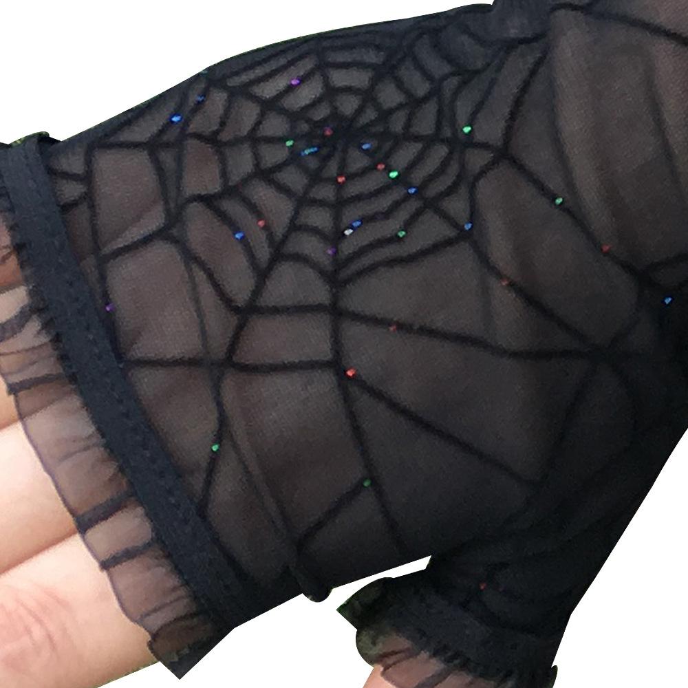 Black spiderweb gloves with a close view of scattered reflective sequins on the mesh.