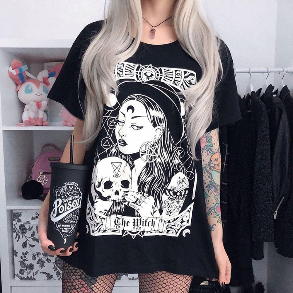 Black The Witch tarot-style graphic T-shirt worn with the skull-holding figure and banner visible.