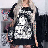 Black The Witch tarot-style graphic T-shirt worn with the skull-holding figure and banner visible.