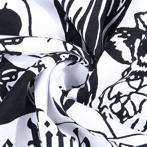 Black The Witch tarot-style graphic T-shirt with a close view of the folded printed fabric.