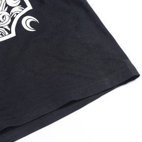 Black The Witch tarot-style graphic T-shirt with a close view of the lower hem.