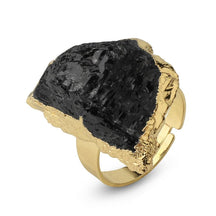 Black tourmaline ring with a rugged dark stone face surrounded by a narrow gold-tone edge.