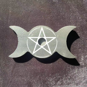Top view of the empty triple moon candle holder, showing one central candle opening inside the pale pentagram.