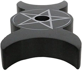 Long angled view of the empty black candle holder, showing the nearest crescent shape and the central star and circle design.