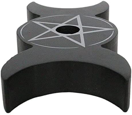 Long angled view of the empty black candle holder, showing the nearest crescent shape and the central star and circle design.