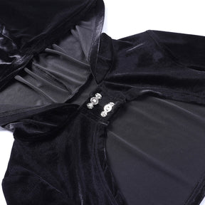 Close-up of the black velvet bolero's hood edge and two decorative silver-tone clasps above the curved front opening.