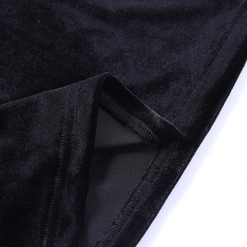 Close-up of the black velvet sleeve edge turned back to show the seam and reverse side of the fabric.