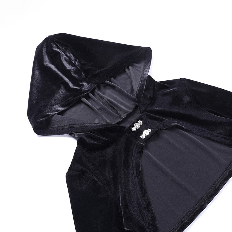 Black velvet hooded bolero laid flat on white, showing the hood opening, cropped body and two ornate front clasps.