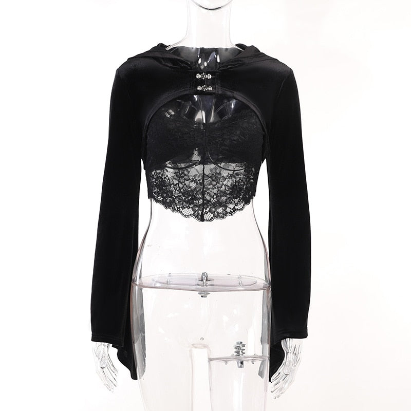 Front view of the black velvet bolero on a clear mannequin with a separate lace camisole underneath. The long sleeves fall beside the torso.