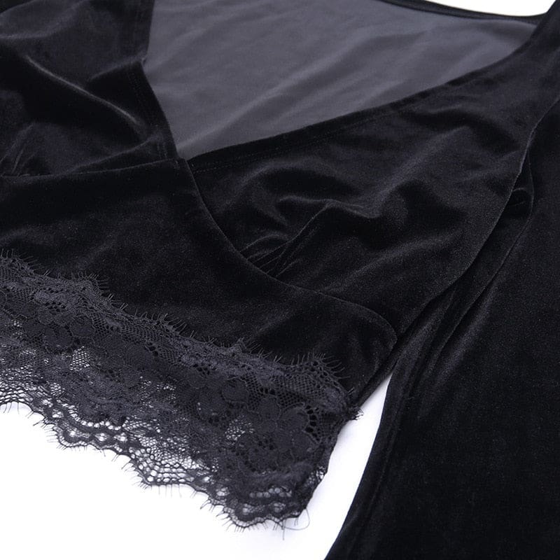 Flat close-up of the black velvet crop top’s V-neck and wide scalloped floral lace hem against white.