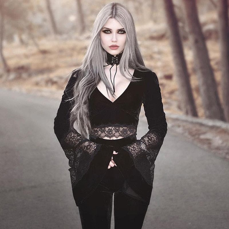 Closer outdoor portrait of a silver-haired model wearing the V-neck velvet crop top, with the lace cuffs folded near the waist.