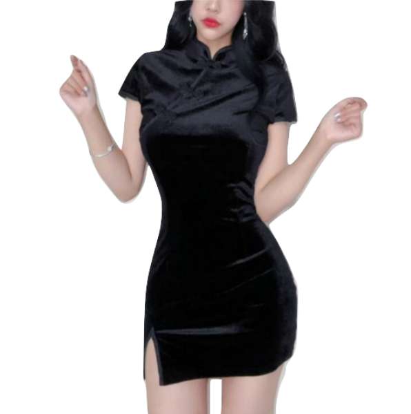 Black velvet mini dress worn from the front, showing its mandarin collar, short sleeves, fitted shape and side slit.