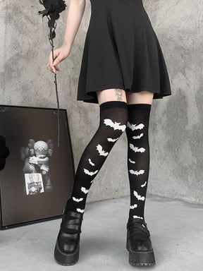 Black over-the-knee stockings with white bats shown in a full leg outfit view.