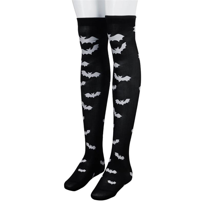 Black over-the-knee stockings with white bats shown on mannequin legs.
