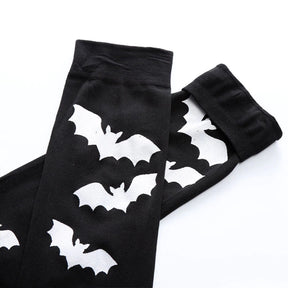 Black over-the-knee stockings with white bats with the upper cuffs and bat pattern laid flat.