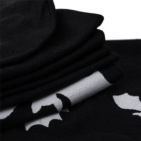 Black over-the-knee stockings with white bats with a close view of the black fabric and white bat detail.
