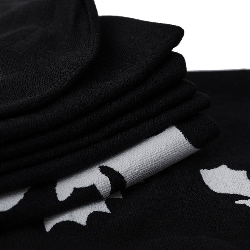Black over-the-knee stockings with white bats with a close view of the black fabric and white bat detail.