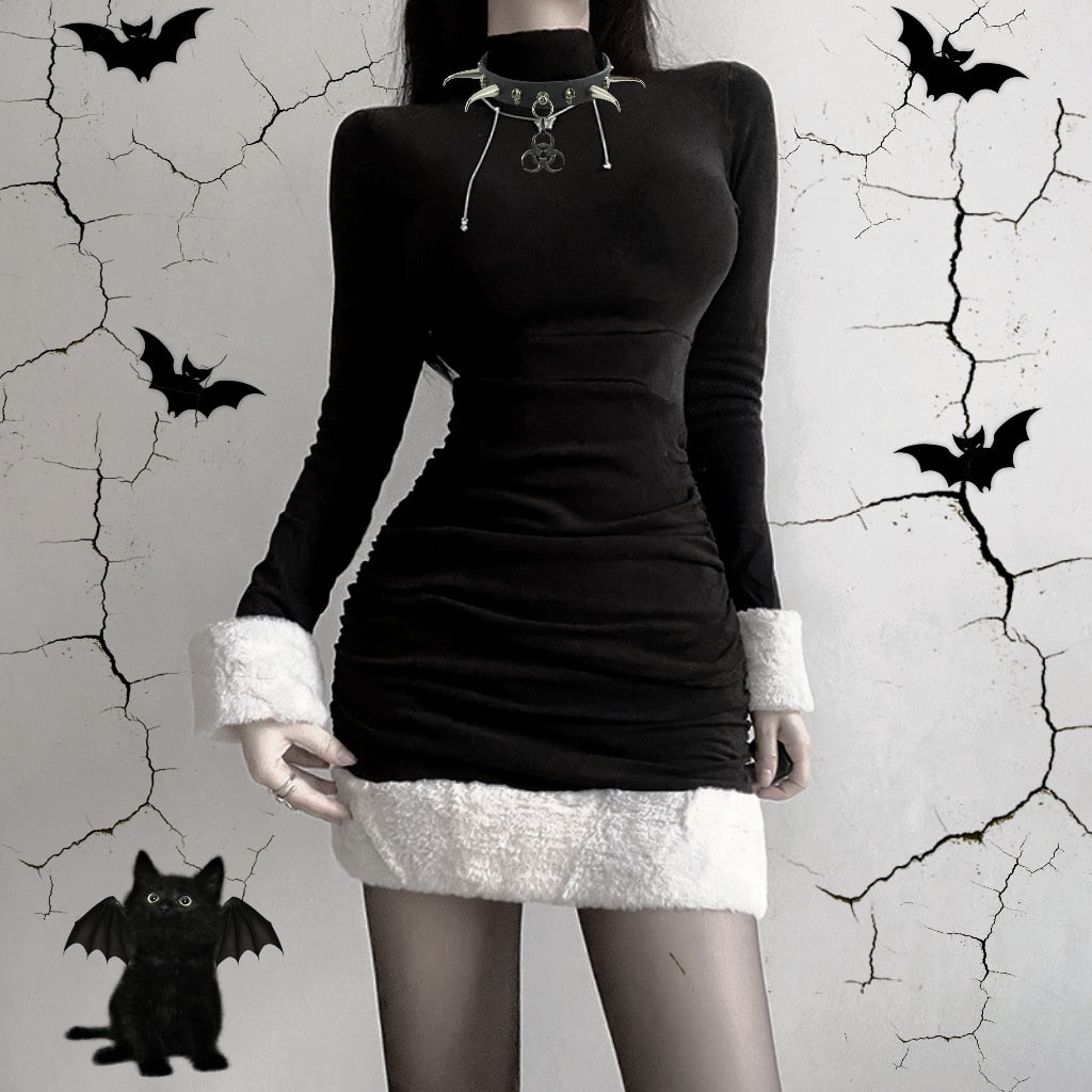 Black holiday mini dress with white fluffy cuffs and hem shown in a front outfit view with a bat backdrop.