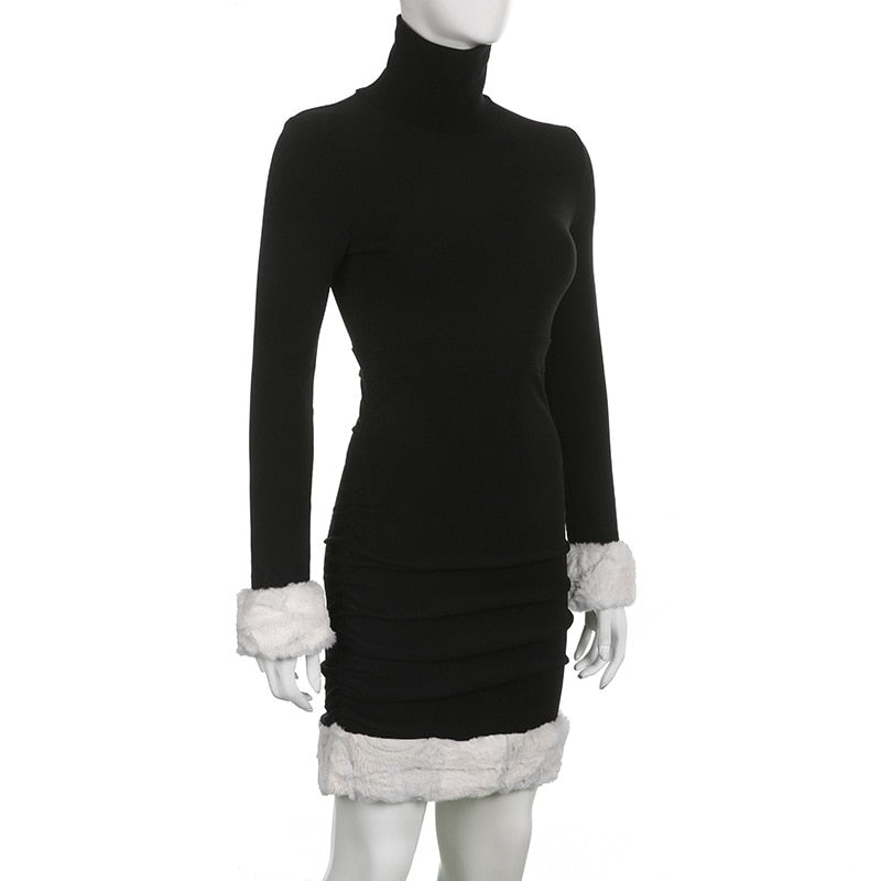 Black holiday mini dress with white fluffy cuffs and hem displayed at a three-quarter angle.