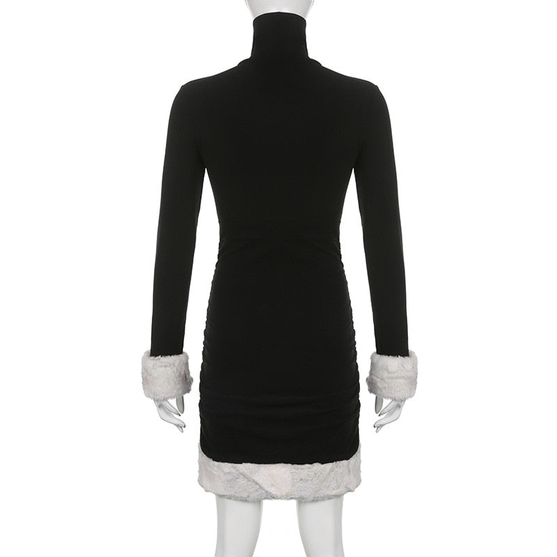 Black holiday mini dress with white fluffy cuffs and hem displayed from the back.