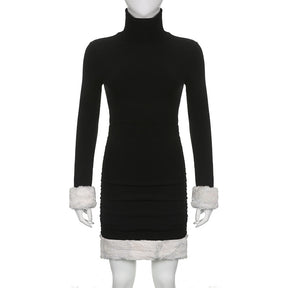 Black holiday mini dress with white fluffy cuffs and hem displayed from the front on a mannequin.