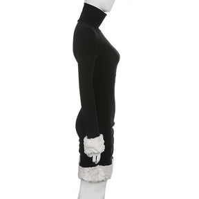 Black holiday mini dress with white fluffy cuffs and hem displayed in profile.