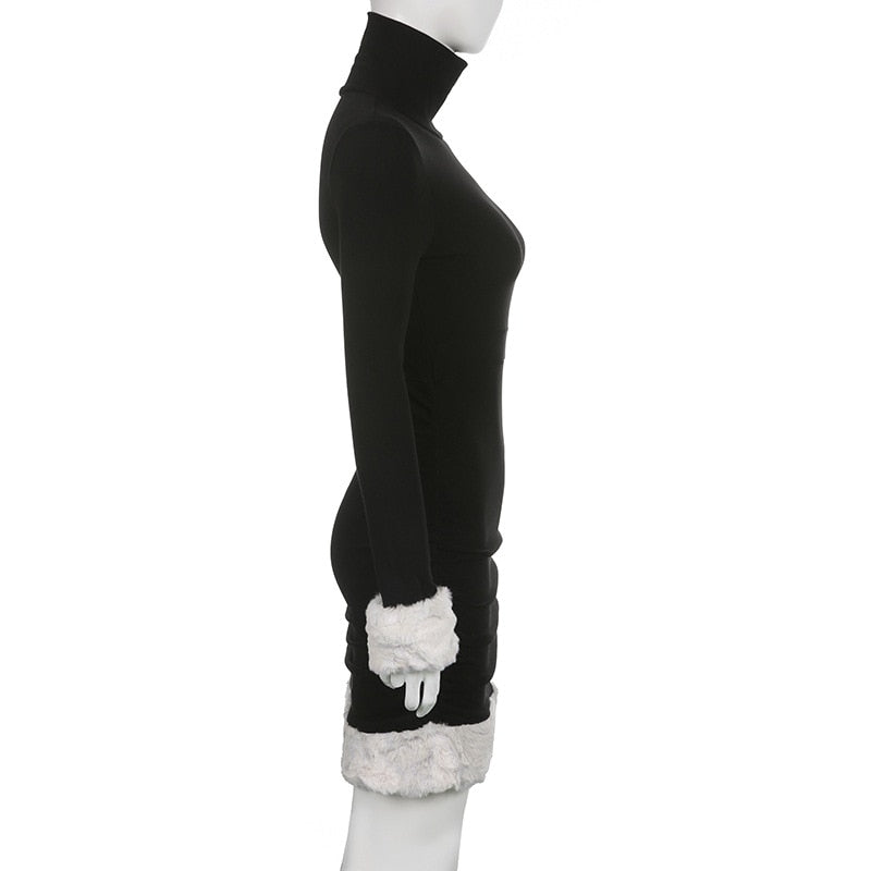 Black holiday mini dress with white fluffy cuffs and hem displayed in profile.