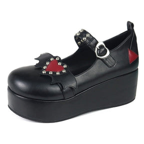 Black Winged Heart platform shoe shown from a three-quarter angle, with red heart decoration, silver-tone studs and heart-shaped buckle visible.