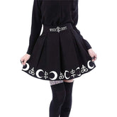 Black pleated Witch Craft skirt held slightly out at the sides to show the white crescent and ornamental symbol border.