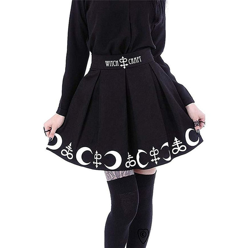 Black pleated Witch Craft skirt held slightly out at the sides to show the white crescent and ornamental symbol border.