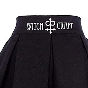 Close view of the black skirt waistband with white Witch Craft lettering and a central ornamental symbol.