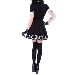 Back view of the black pleated skirt, showing the gathered waistband and white crescent border continuing around the hem.