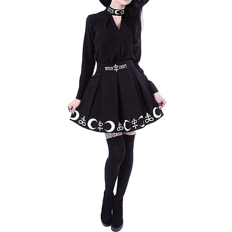 Full outfit view of the black Witch Craft skirt, with the hem held out above thigh-high stockings and black shoes.