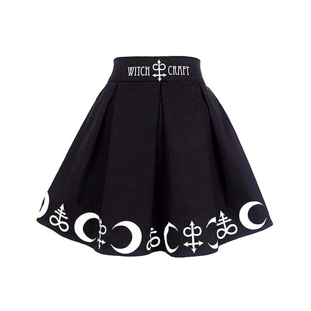 Black Witch Craft skirt displayed alone with deep pleats, a wide lettered waistband and white crescent motifs.