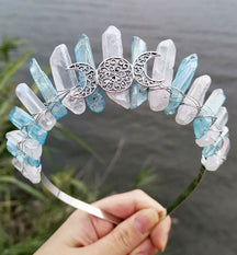 Front view of a blue clear crystal point crown with a silver-tone triple moon emblem and wire-wrapped band.