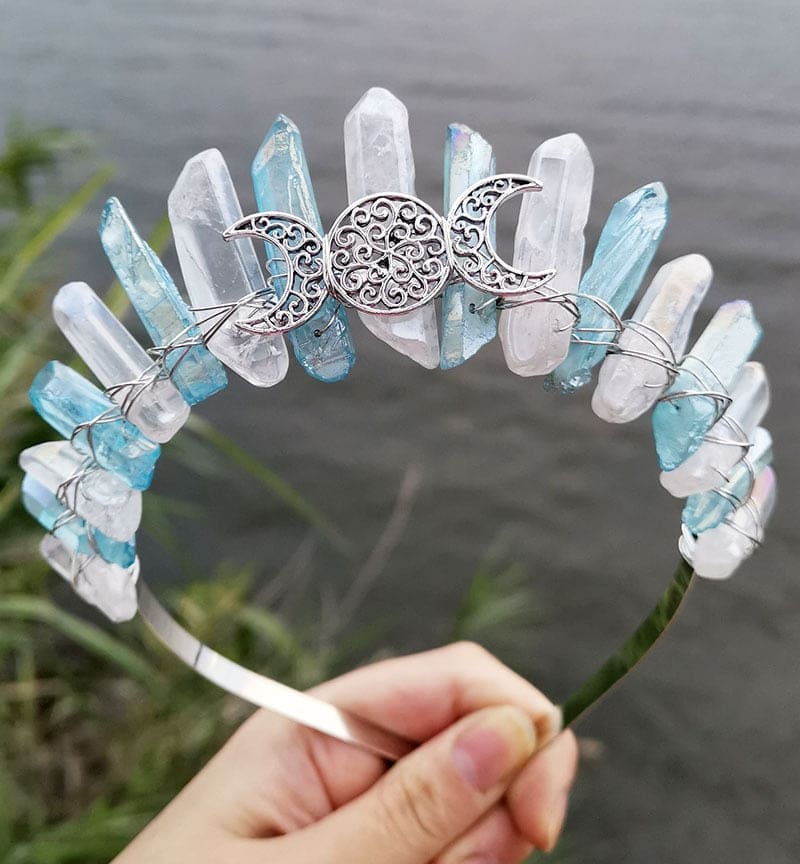 Front view of a blue clear crystal point crown with a silver-tone triple moon emblem and wire-wrapped band.