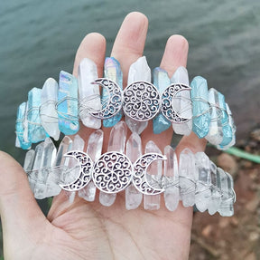 Blue-clear and clear crystal crowns shown as a pair, with ornate silver-tone triple moon emblems at the front.