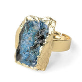Front view of a blue kyanite ring, showing the stone's vertical striations and irregular gold-tone border.