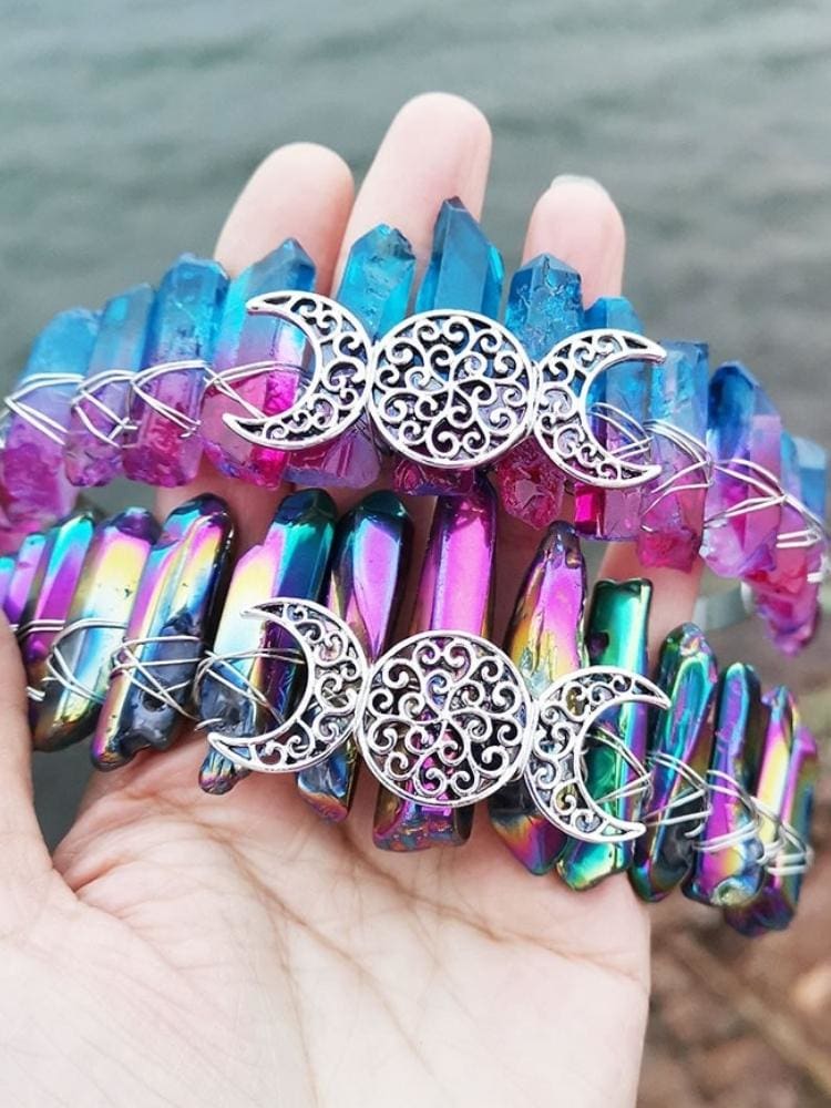 Blue-pink and metallic rainbow crystal crowns shown together, with matching silver-tone triple moon centres.
