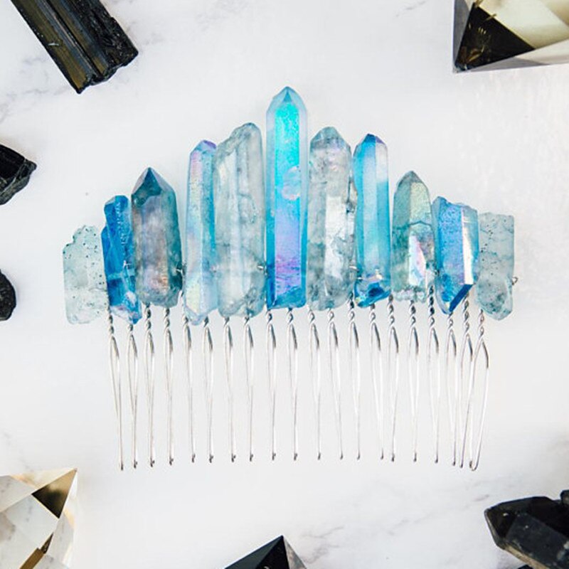 Blue quartz hair comb arranged flat with crystal display props, showing an uneven row of iridescent points above silver-tone teeth.